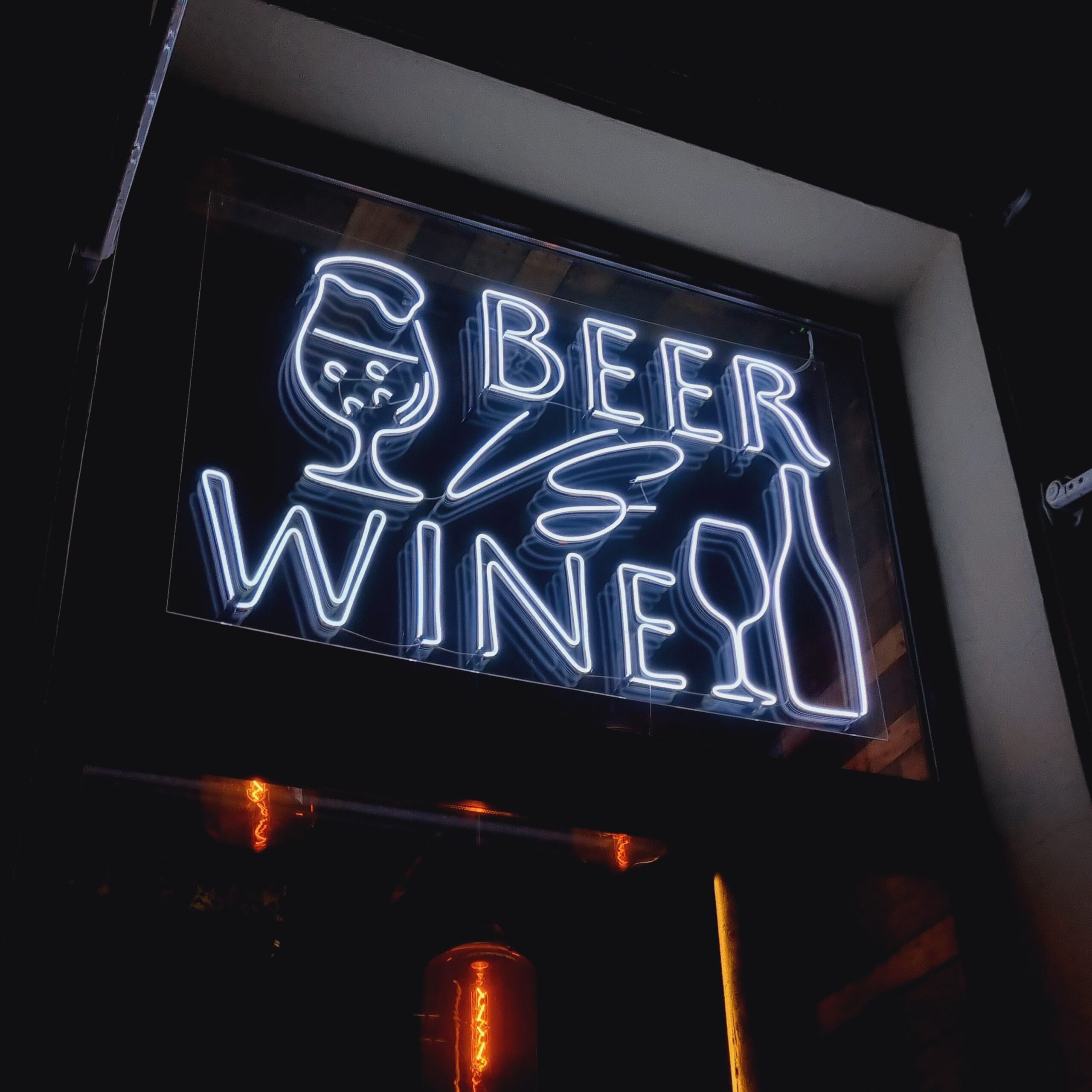 Vibrant neon sign showcasing beer and wine in Saint Petersburg, Russia, at night.