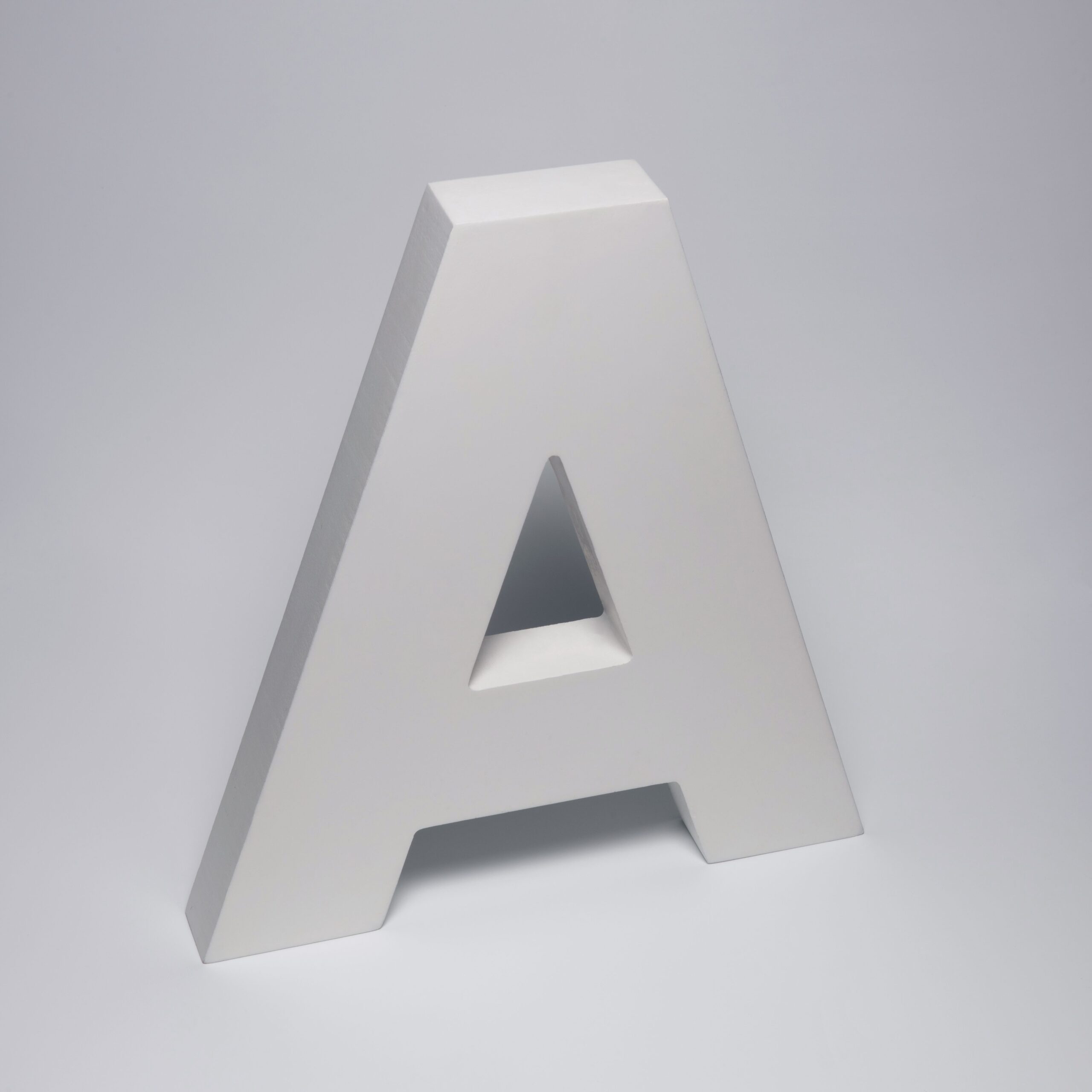 3D white letter A standing against a subtle gray background, perfect for design or typography projects.